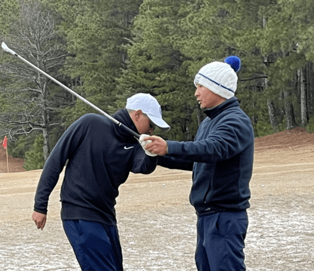 A student and a coach at Energy1st Golf in Suwanee, GA